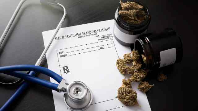 a prescription pad with a stethoscope and medical cannabis on top